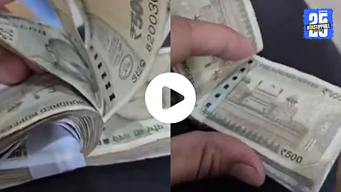 A man demonstrates a 500 rupee cash bundle scam where folded notes are hidden, causing unsuspecting buyers to lose ₹1,000.