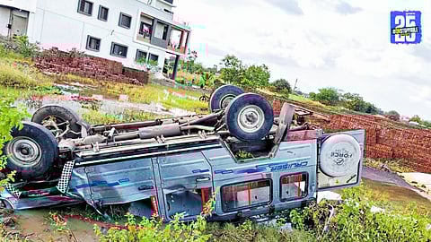 Emergency responders and locals at the site of a jeep overturn on Karjat road, where dogs caused an unexpected obstruction, injuring three passengers.