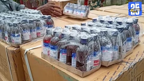Police officials display seized banned cough syrup bottles worth ₹2 crore recovered from a railway goods train during a major anti-smuggling operation.