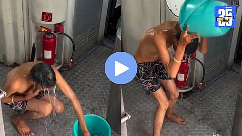 A young man seen bathing near the train gate at Jhansi railway station — video goes viral on social media, prompting RPF action.