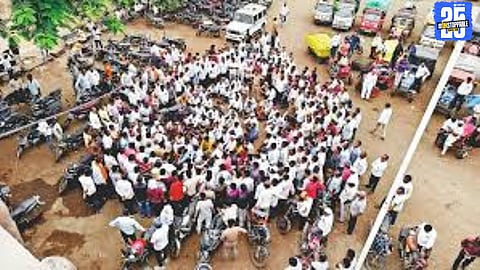 An agitated farmer protests in front of the Newasa Tehsil office, demanding justice and aid for deprived farmers affected by crop losses.