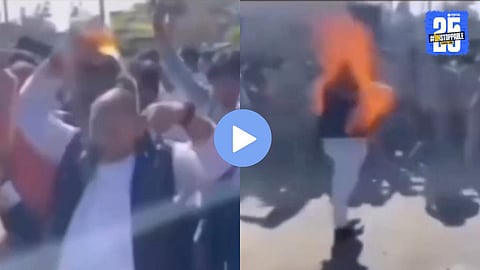 Protest leader drenched in petrol catches fire after a worker ignites him during a chaotic demonstration.