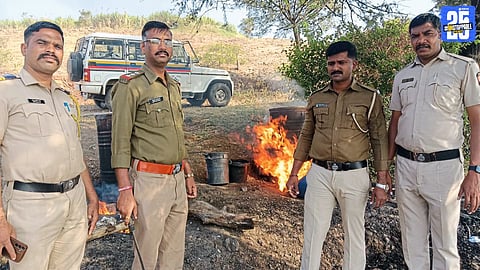 Police destroying seized illicit liquor stock during action at Math village.