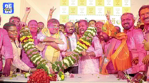 BJP workers celebrate election victory with colours and drums at the Kolhapur party office.