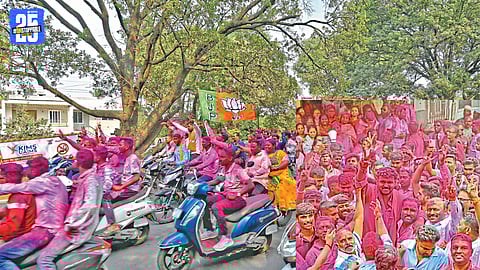 Victorious candidates and supporters celebrate with gulal and fireworks after Sangli municipal election results.