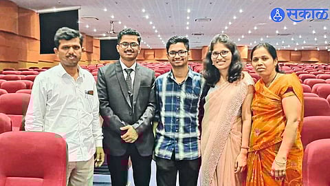 Proud teacher father with his three children who achieved remarkable success in the medical field.