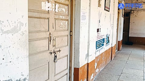 Citizens waiting at Madha tehsil office as record room remains closed, causing inconvenience.