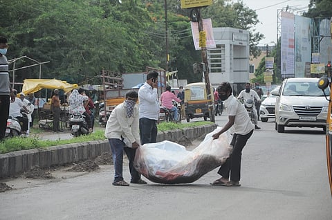 Dead body wrapped in plastic from a ambulance fell on the street