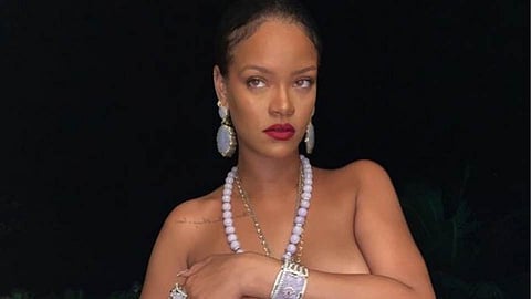 popular popstar Rihanna poses topless for her lingerie brand with Ganesh necklace