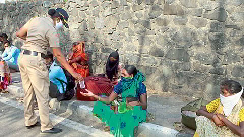 मुंबई - लॉकडाउनच्या काळात स्थलांतरित मजुरांना अन्नवाटप करताना महिला पोलिस कर्मचारी.