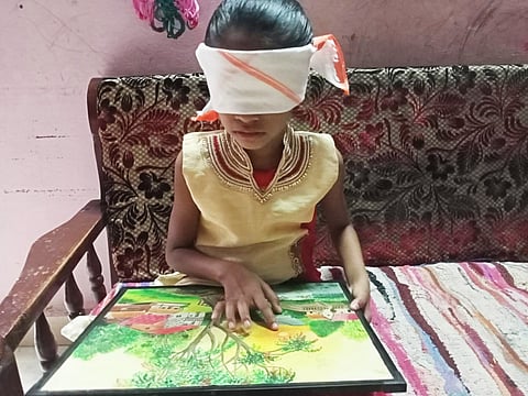 This girl reads the book blindly and also recognizes color