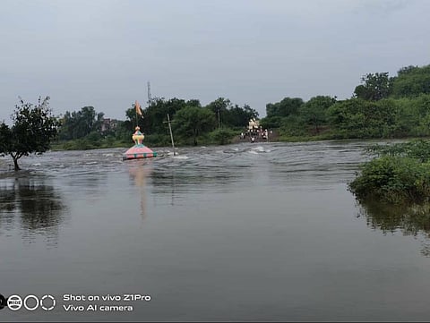 As water is flowing from the bridge over the river Bhogawati, traffic has come to a standstill and life has been disrupted.jpg