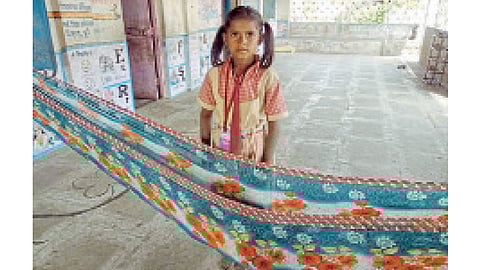 माळेगाव (ता. खेड) - रेश्माने शाळेच्या व्हरांड्यात बांधलेली झोळी.