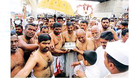 पाडेगाव - संतश्रेष्ठ ज्ञानेश्वर माउलींच्या पादुकांना शुक्रवारी नीरा नदीत स्नान घातल्यानंतर पालखी रथाकडे पादुका नेताना  मानकरी.