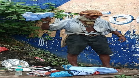 Begger is wearing used PPE kit at funeral