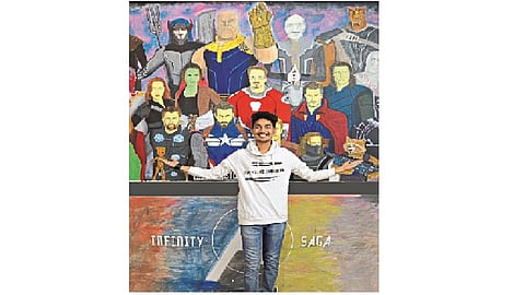 He is drawing on the wall without scratching