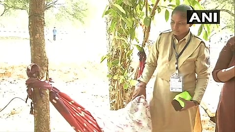 Woman police constable carries one-year-old son on her duty in Ahmedabad