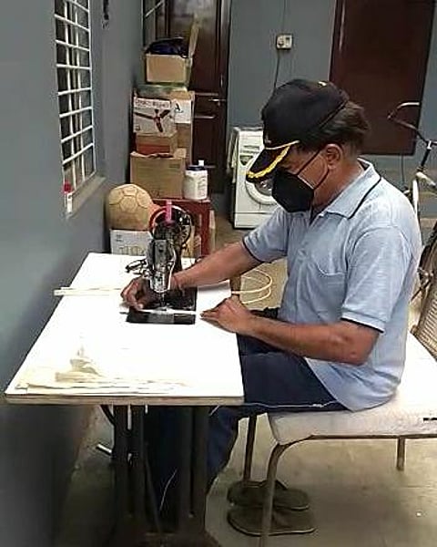 retired colonel Sawant is sewing masks on a sewing machine in kolhapur