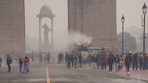 An anti-smog gun being used to spray water droplets to curb air pollution, near India Gate