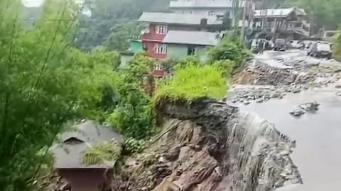Section of a road damaged due to landslides triggered by incessant rainfall, at Mangan in North Sikkim
