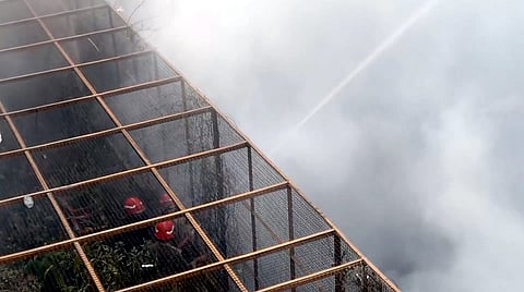 Firefighters douse a fire at Chandni Chowk, in New Delhi