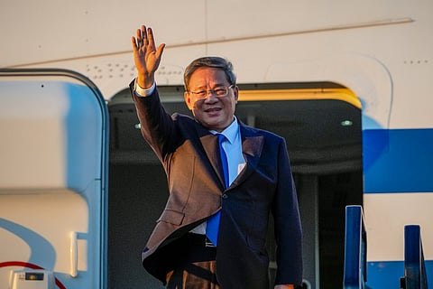 Chinese Premier Li Qiang waves on his arrival at Adelaide Airport, Australia,