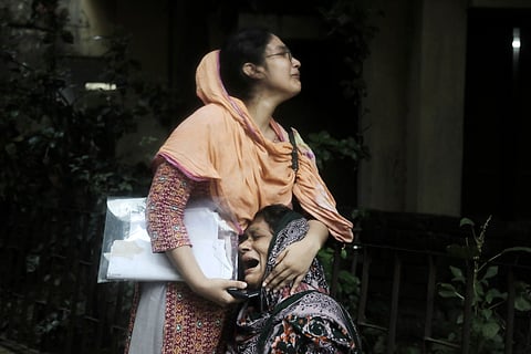 Sanjida, left, consoles her mother as she breaks into tears after receiving the dead body of her son, who was shot during a clash between the police and anti-quota protesters, at a morgue in Dhaka