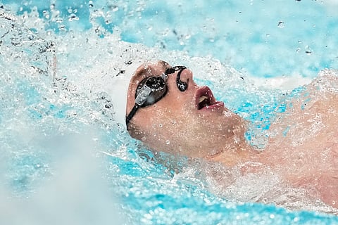 Hunter Armstrong, of the United States, competes during a heat in the men's 100-meter backstroke at the 2024 Summer Olympics