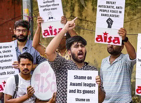 Members of AISA raise slogans during a demonstration in solidarity with students protesting in Bangladesh against the quota system for government jobs