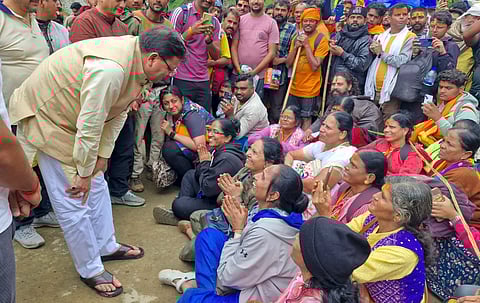 Uttarakhand Chief Minister Pushkar Singh Dhami meets the devotees waiting for rescue during his visit to the areas affected by heavy rains in Kedarghati