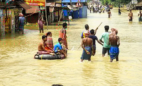 Locals at a flood-affected area, in Paschim Medinipur district, West Bengal