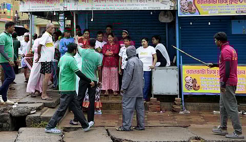 Disaster Management Group (DMG) personnel interact with people during evacuation at Digha ahead of the landfall of Cyclone 'Dana', in Purba Medinipur district, West Bengal
