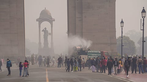 An anti-smog gun being used to spray water droplets to curb air pollution, near India Gate