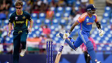 India's Suryakumar Yadav runs past Australia's bowler Adam Zampa during an ICC Men's T20 World Cup cricket match at Darren Sammy National Cricket Stadium in Gros Islet, Saint Lucia, Monday