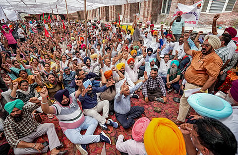 Members of the Coordination Committee of Paramedical and Health Workers and other government employees raise slogans outside Guru Nanak Hospital OPD during a statewide strike, on Saturday | PTI