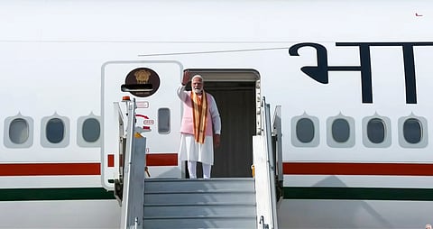 Prime Minister Narendra Modi gestures as he boards the flight for Tashkent, Uzbekistan, in New Delhi | PTI