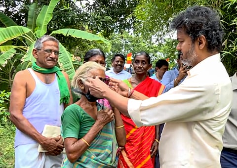 Tamil Nadu Chief Minister C Joseph Vijay adjusts sunglasses on an elderly woman during his visit to the residence of a farmer, in Salem district, Tamil Nadu | PTI