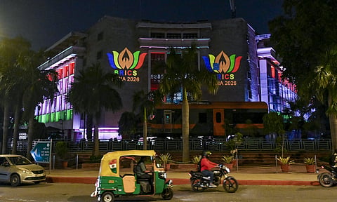 Vehicles move on a road near the Rail Bhavan, illuminated with decorative lighting and projection displays ahead of the 18th BRICS Summit 2026, in New Delhi, on Tuesday | PTI