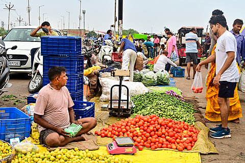 People buy vegetables at a wholesale market, in Prayagraj | Representational image/PTI