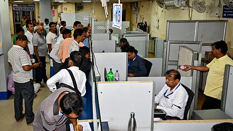 Customers visit a bank, ahead of the United Forum of Bank Unions' three-day nationwide bank strike, in Varanasi, on Sunday | File image/PTI