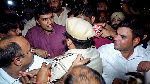 AAP Delhi president Saurabh Bharadwaj argues with a police official during a protest march, in New Delhi | File image/PTI