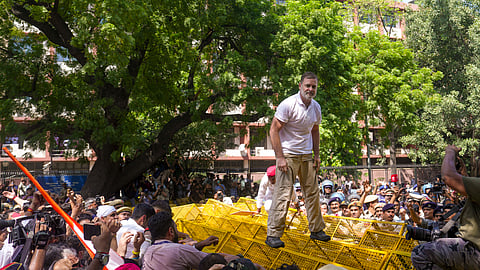 Rahul Gandhi climbs atop police barricades after being stopped by security personnel during a protest march, in New Delhi, on Tuesday | File image/PTI