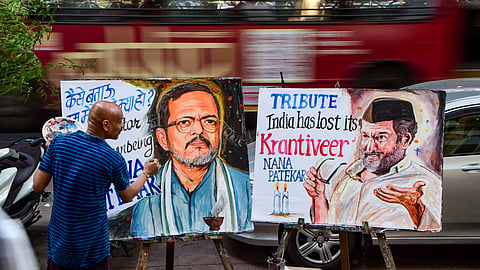 A teacher of the Gurukul School of Art paints portraits of veteran actor Nana Patekar in tribute to the late actor, in Mumbai | PTI