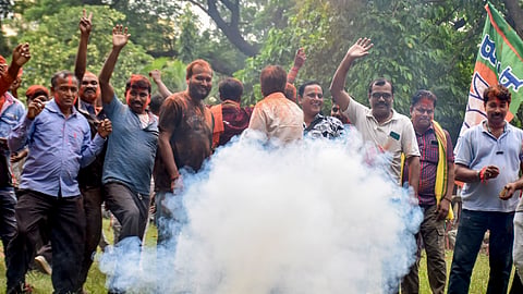 BJP supporters burst firecrackers as they celebrate amid the counting of votes for the Rejinagar Assembly by-election, in Murshidabad district, on Friday | PTI