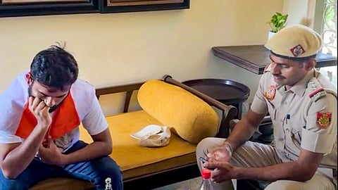 A Delhi Police official with Cockroach Janta Party (CJP) founder Abhijeet Dipke, ahead of the party's 'Lehra Do Tiranga' rally, at Dipke's residence in New Delhi, on Friday | PTI