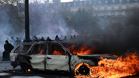 A car burns at Place de La Republique during a protest against rising living costs in Paris, on Saturday | PTI