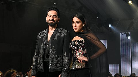 Sara dazzles in black draped ensemble while Ayushmann walks the ramp in structured jacket featuring intricate silver detailing