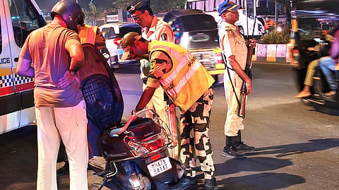 Police personnel impose security cordon as they inspect a vehicle after gunmen opened fire at Bollywood actor Tiger Shroff's car | File image/PTI