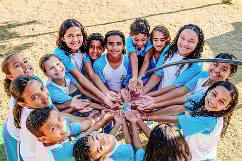 School children from São Desiderio in Brazil enjoying clean water made accessible through a water tank and water treatment system installed by the Cargill Currents project