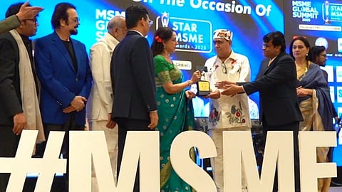 Laxman Das Bajaj, Chairman of Vezlay Foods, receiving the award from veteran actress and Member of Parliament Hema Malini